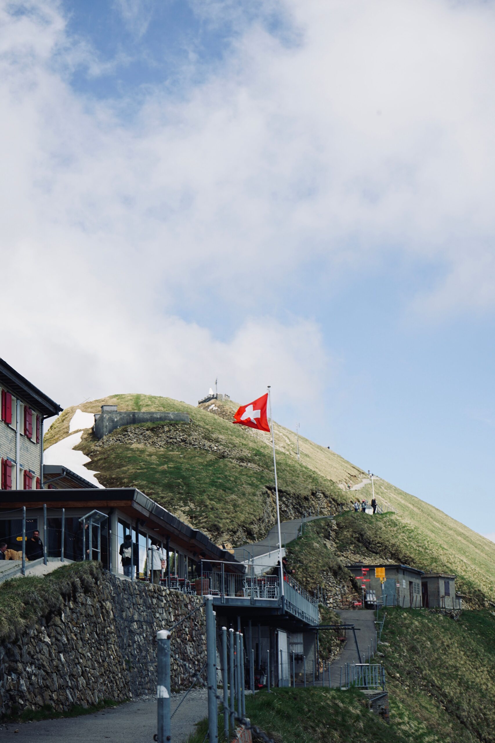 Drapeau suisse et paysage alpin pour un frontalier en fin de mission en Suisse